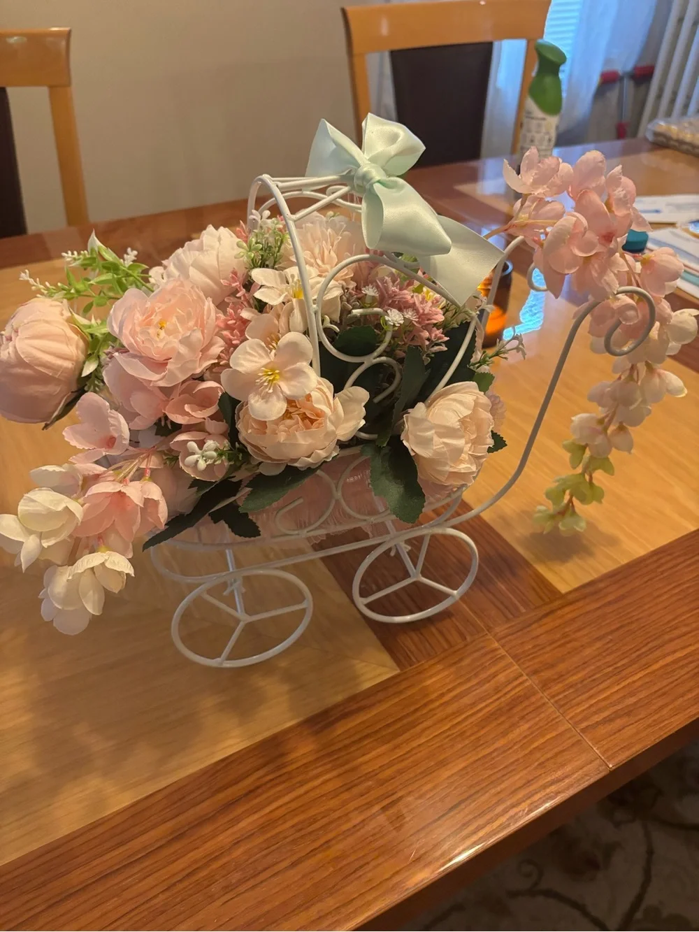 White Metal Baby Carriage Floral Centerpiece with Pink Silk Flowers.